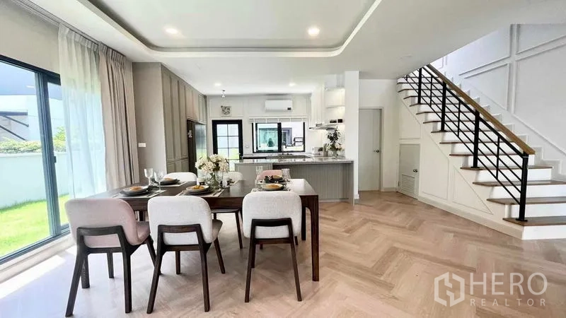Detached House for rent in Bang Phli, Samut Prakan - Open-plan ground floor with dining, kitchen, staircase and garden-facing windows