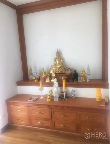 Detached House for sale in Saphan Sung, Bangkok - Dedicated prayer or meditation alcove with built-in wooden cabinetry and display shelves.