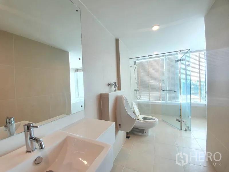 คอนโด ให้เช่าในRatchathewi, Bangkok - ห้องน้ำสว่างกระจกบานใหญ่ อ่างล้างหน้า สุขภัณฑ์ โถปัสสาวะ และตู้ฝักบัวกระจก.