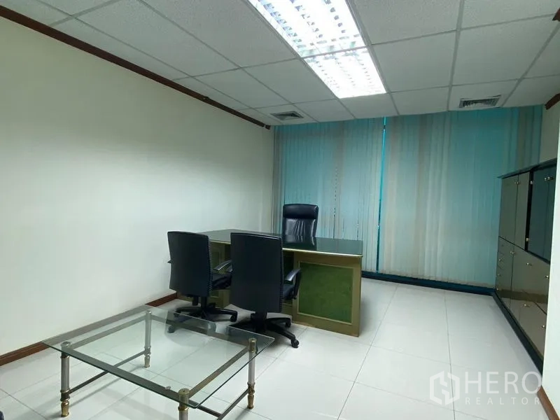 Office Space for rent in Huai Khwang, Bangkok - Executive office with desk, guest chairs, glass coffee table and storage cabinets.