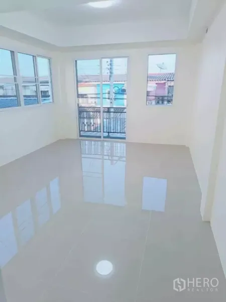 Home Office for rent in Bang Phli, Samut Prakan - Bright upper-floor room with glossy tile floor, corner windows and a small balcony.