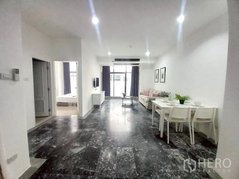 Condominium for rent in Watthana, Bangkok - Living zone with dining set and corridor to bedrooms and bathrooms.