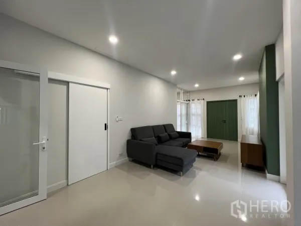 Detached House for rent in Saphan Sung, Bangkok - Minimalist living room view showing sliding door and neutral finishes.