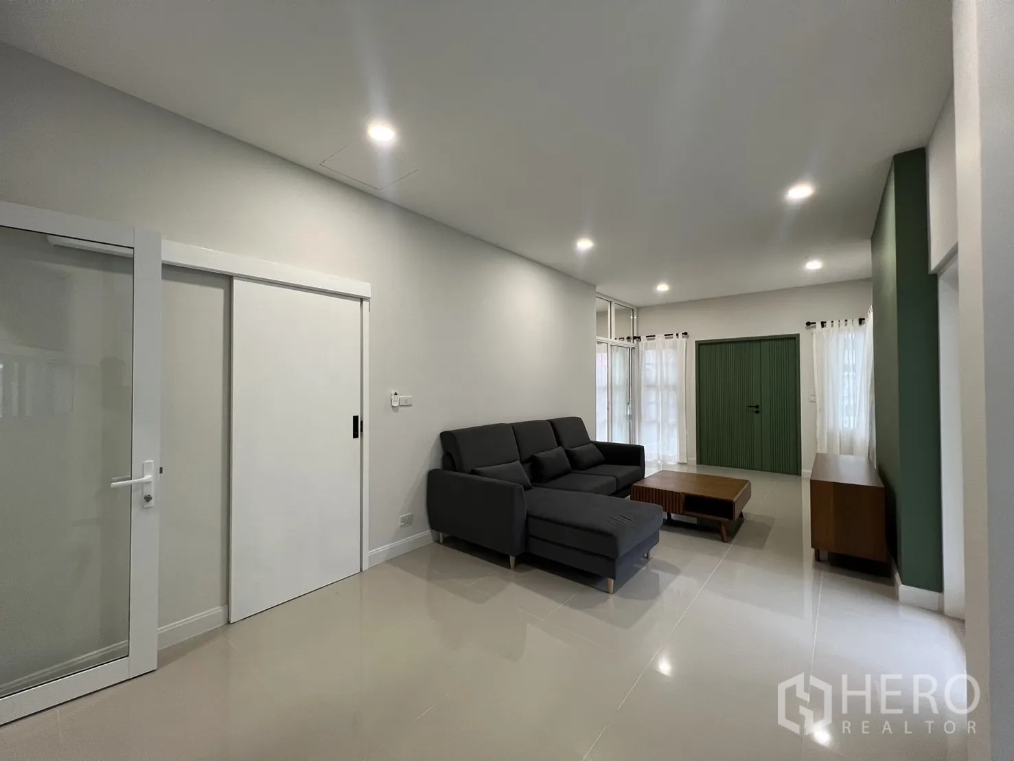 Detached House for rent in Saphan Sung, Bangkok - Minimalist living room view showing sliding door and neutral finishes.