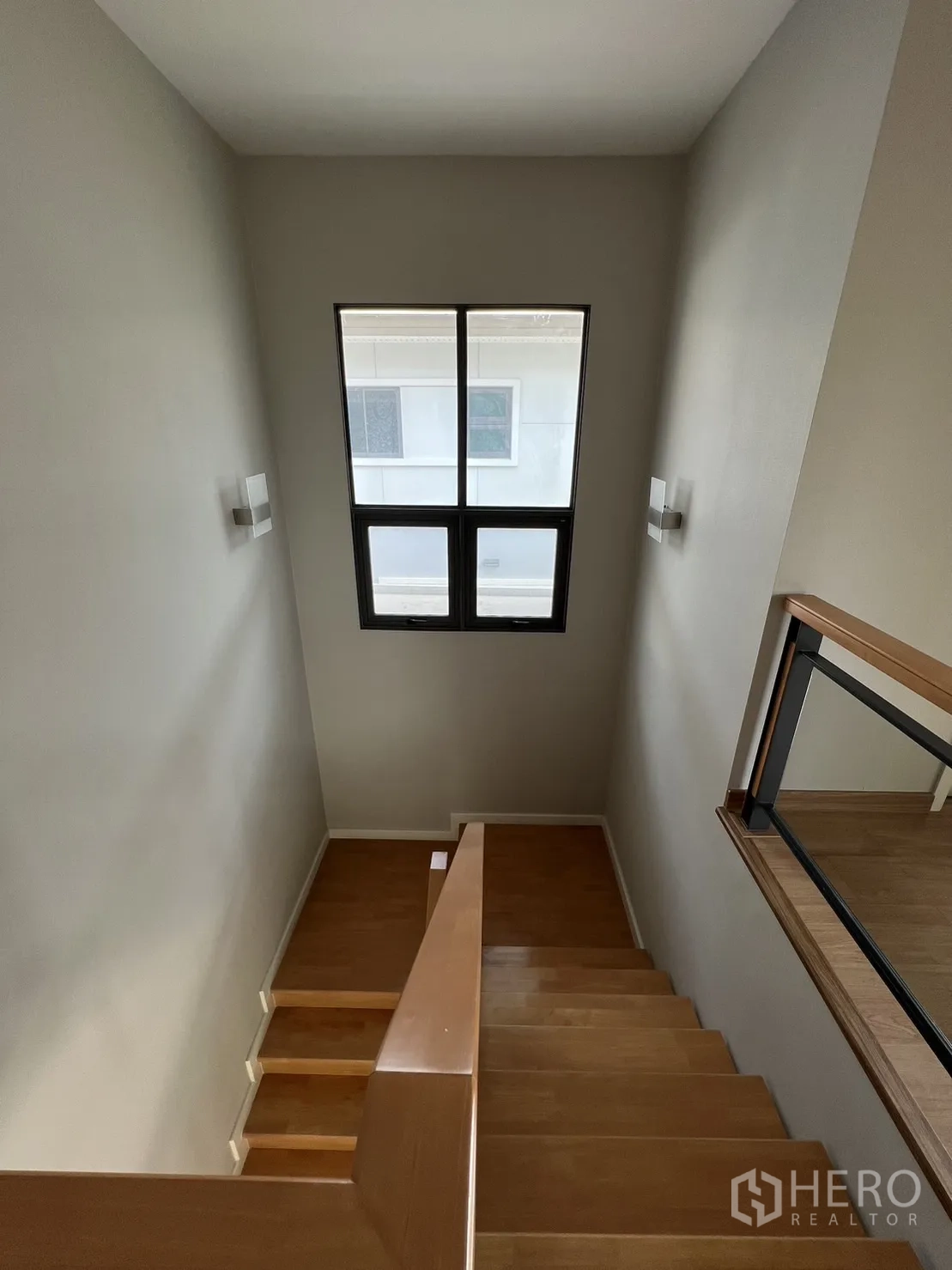 Detached House for sale in Suan Luang, Bangkok - Staircase with wooden steps and tall window for natural light.