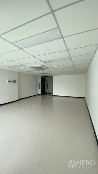Office Space for rent in Watthana, Bangkok - Empty office room with suspended ceiling, air-conditioning vent, and clean light flooring.