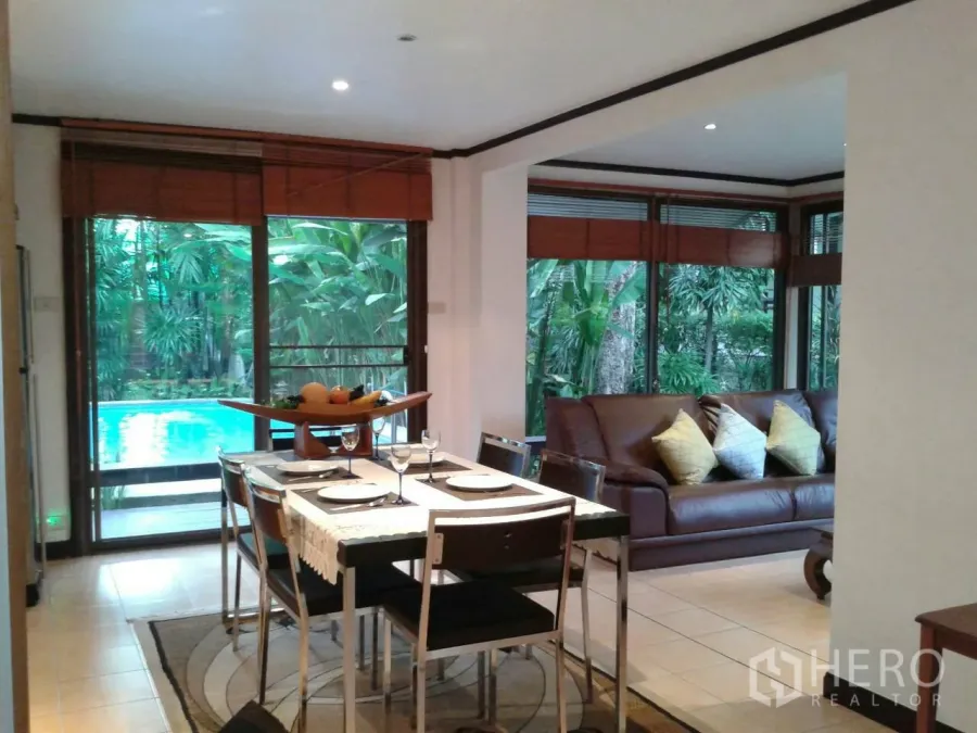 Detached House for rent in Suan Luang, Bangkok - Open-plan dining area with sliding glass doors to a private pool and lush garden views.