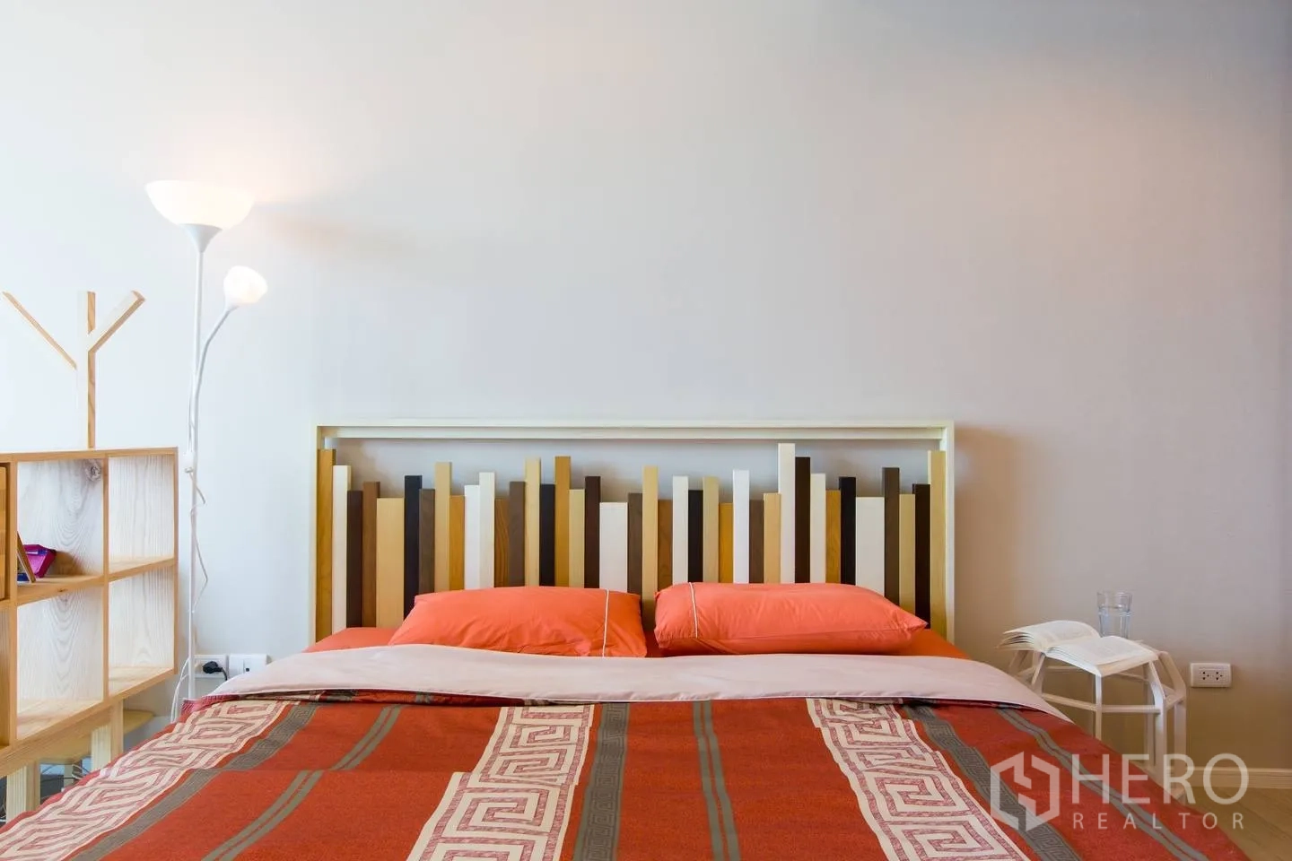 คอนโด ให้เช่าในWatthana, Bangkok - ห้องนอนอบอุ่น หัวเตียงดีไซน์เรขาคณิต โต๊ะหัวเตียง โคมไฟ และผ้าปูที่นอนโทนอุ่นในคอนโดวัฒนา