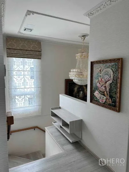 Detached House for sale in Bang Phli, Samut Prakan - Stair landing with window, chandelier and framed artwork