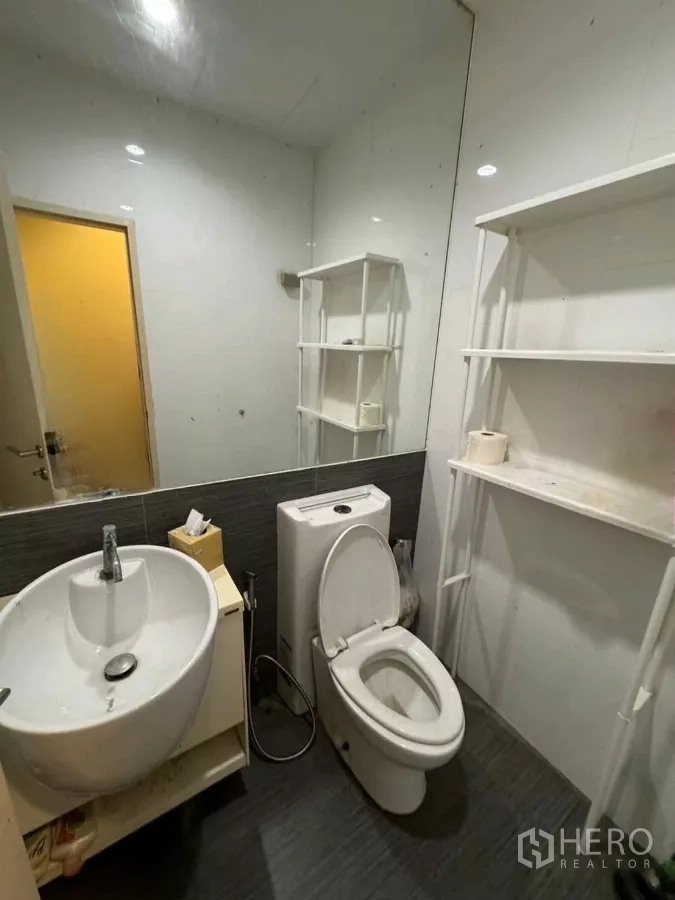 Detached House for sale - Bathroom with large mirror, round basin, toilet, and open storage shelves.