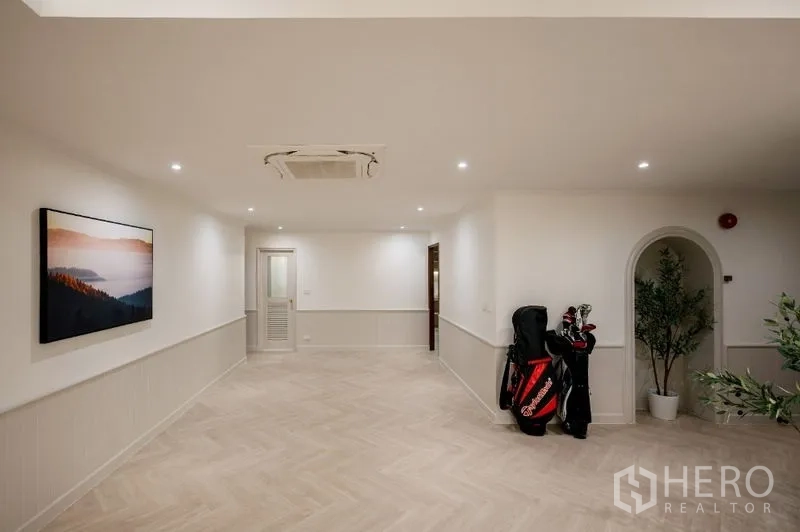 Condominium for sale - Multi-purpose room with herringbone floor and golf bags.