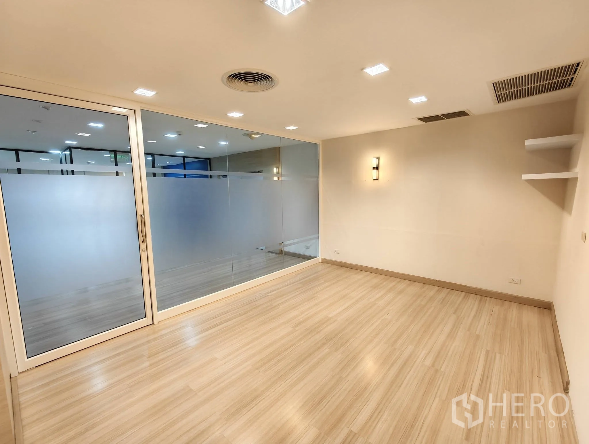 Office Space for rent in Lak Si, Bangkok - Compact meeting room with frosted glass wall and shelving.