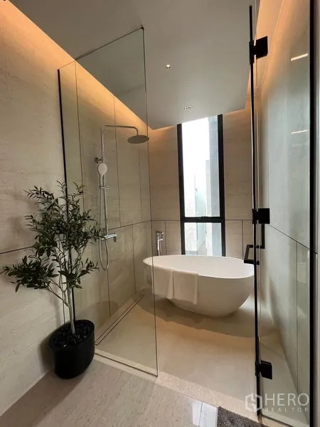 Home Office for sale in Prawet, Bangkok - Luxury bathroom with glass shower, freestanding bathtub, and a tall window.