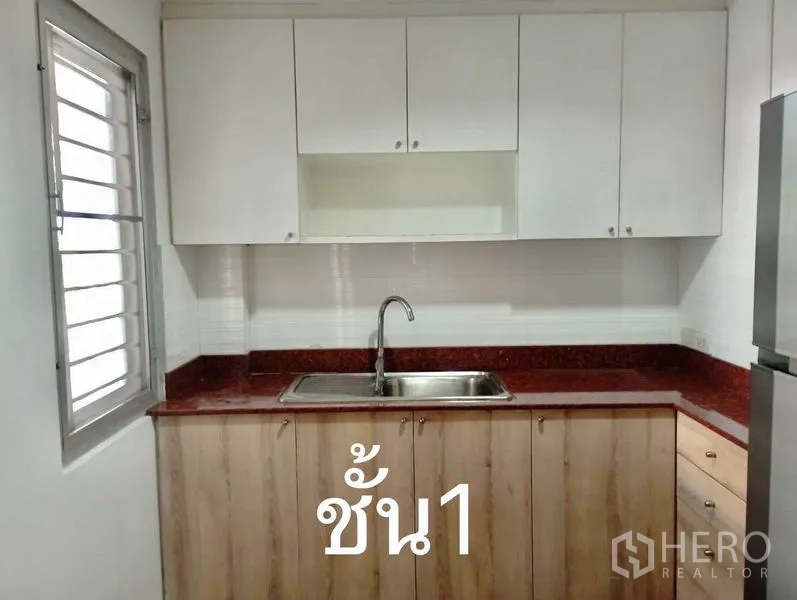 Home Office for rent or sale in Suan Luang, Bangkok - First‑floor pantry kitchen with red countertop, sink and upper cabinets.