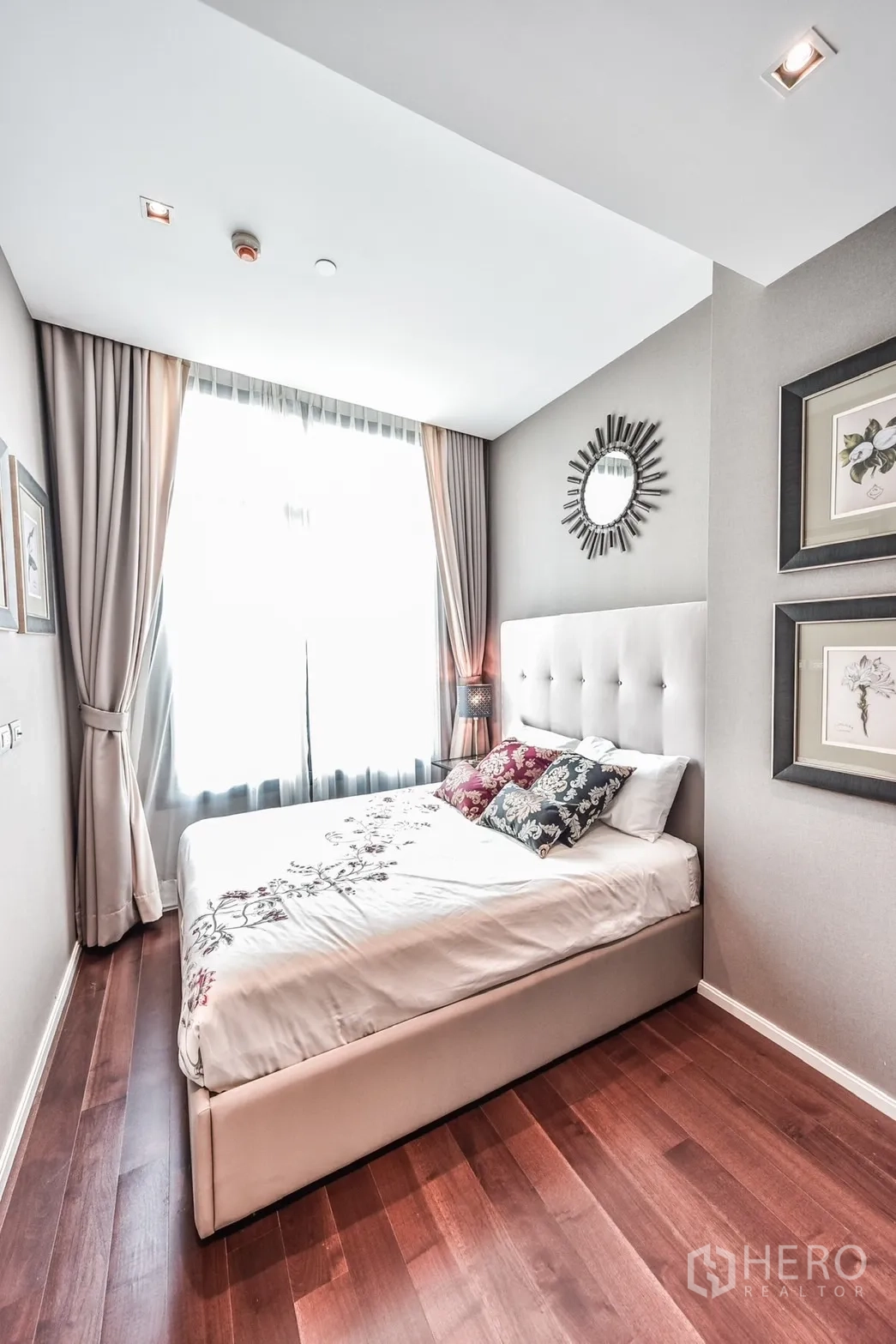Condominium for rent or sale in Watthana, Bangkok - Second bedroom with tufted headboard, large window, soft drapery and wall art.