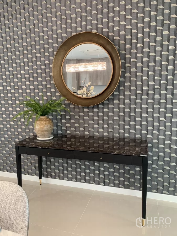 Detached House for rent in Bang Kapi, Bangkok - Console table with round mirror and plant against patterned feature wall in Hua Mak house.