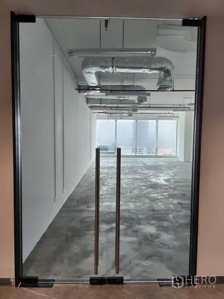 Office Space for rent in Sathon, Bangkok - Frameless glass double doors opening to an open office with city-facing floor-to-ceiling windows.