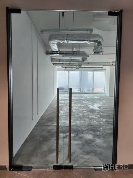 Office Space for rent in Sathon, Bangkok - Frameless glass double doors opening to an open office with city-facing floor-to-ceiling windows.