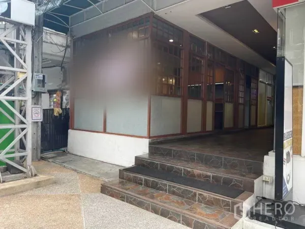 พื้นที่ขายปลีก ให้เช่าในWatthana, Bangkok - ทางขึ้นบันไดสู่ห้องมุม หน้าร้านกระจกกรอบลูกกรงใต้กันสาด ในย่านพร้อมพงษ์