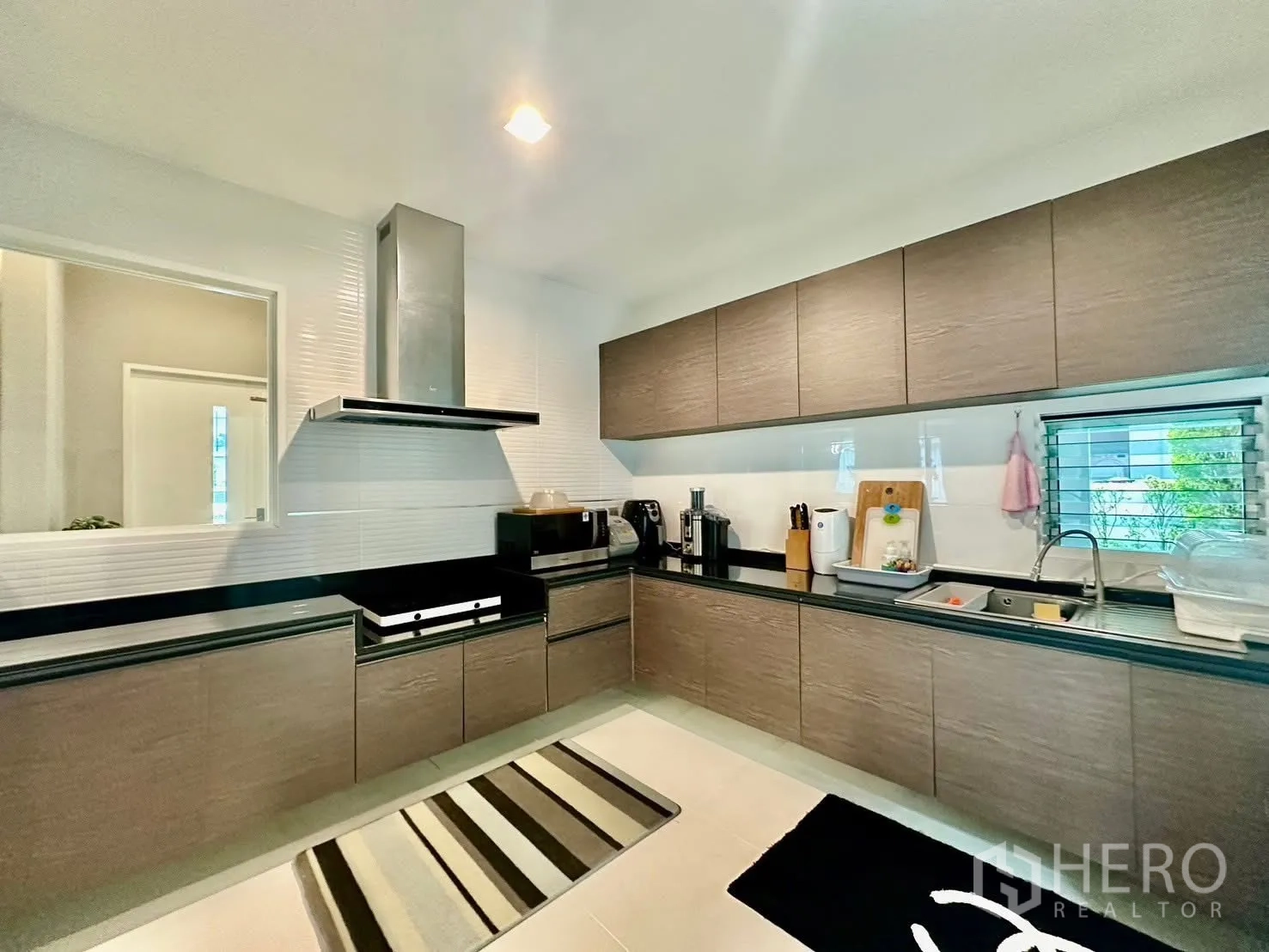บ้านเดี่ยว for rent in Bang Phli, Samut Prakan - ครัวบิวท์อินรูปตัวแอล ตู้ไม้ท็อปหินสีดำพร้อมเครื่องดูดควัน.