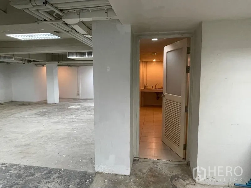 Office Space for rent in Ratchathewi, Bangkok - Doorway from the office leading to internal restroom and sink area.