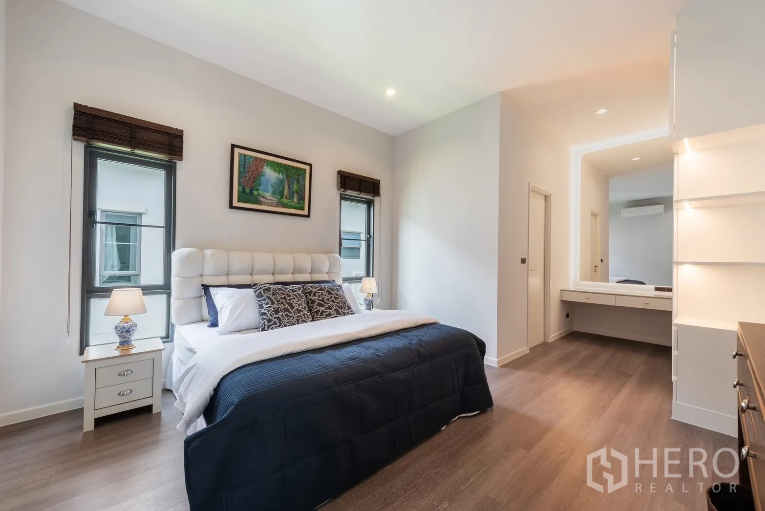 Detached House for rent or sale in Bang Phli, Samut Prakan - Bedroom with soft lighting, bedside tables, and a long built-in vanity.