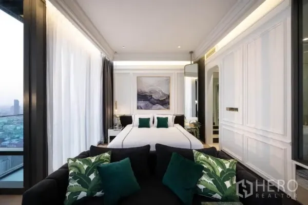 Condominium for rent in Bang Rak, Bangkok - Bright bedroom zone with a king bed, wall paneling and corner windows offering skyline outlooks.