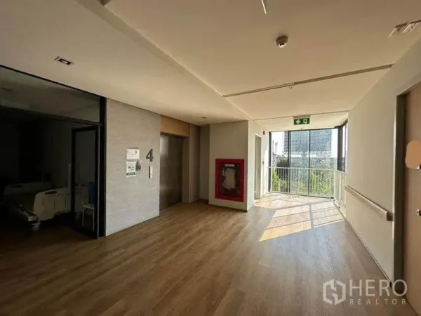 独立商业地产 出租在Bang Kapi, Bangkok - 电梯大堂设消防水带柜与落地窗，引入充足阳光。