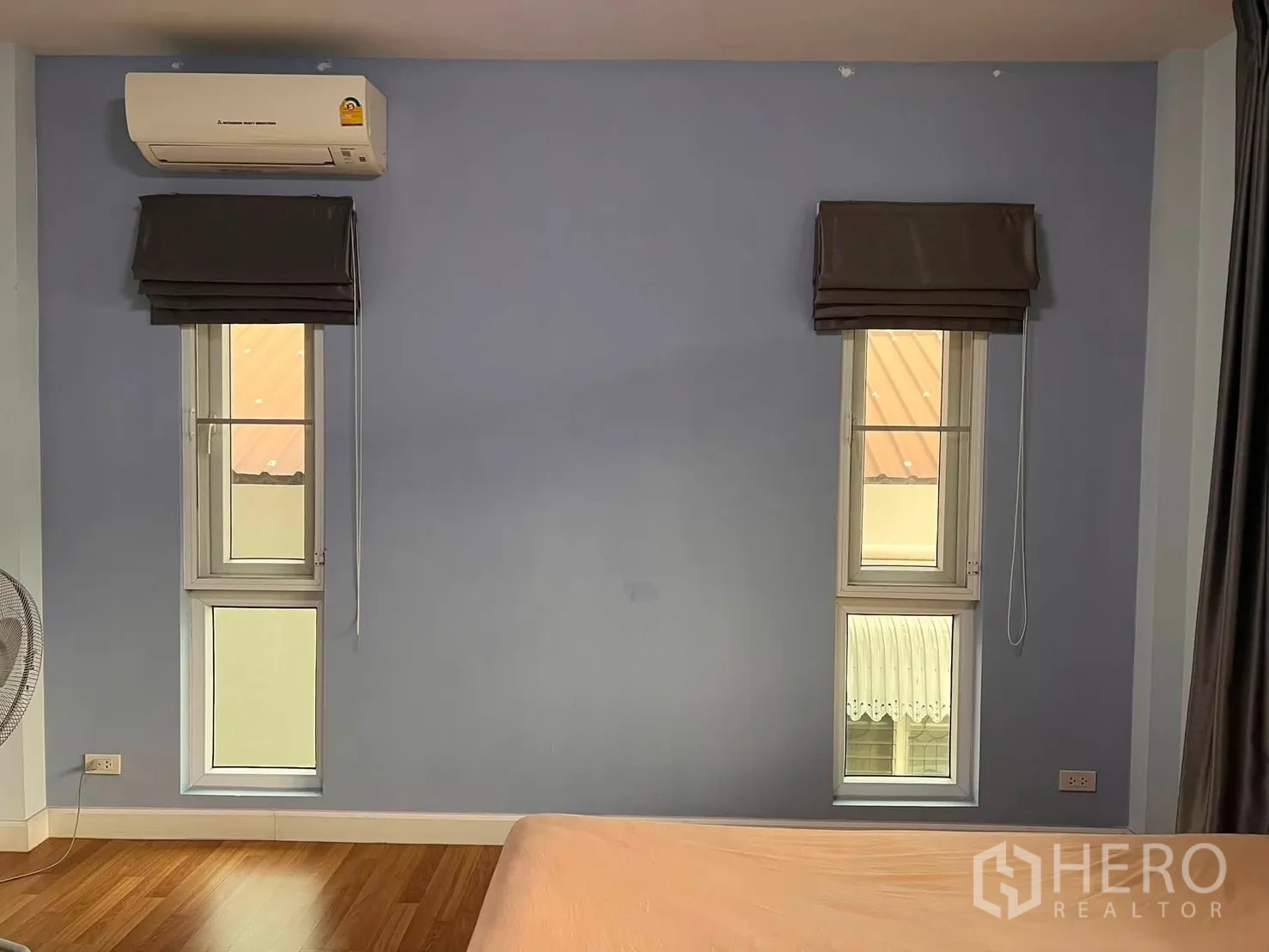 Detached House for rent in Watthana, Bangkok - Bedroom wall with two tall windows and an air conditioner above.