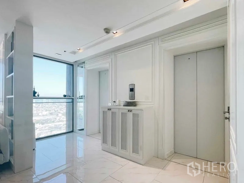 Condominium for rent or sale in Bang Kho Laem, Bangkok - Private lift lobby inside the condo with glossy white walls and a large window city view.