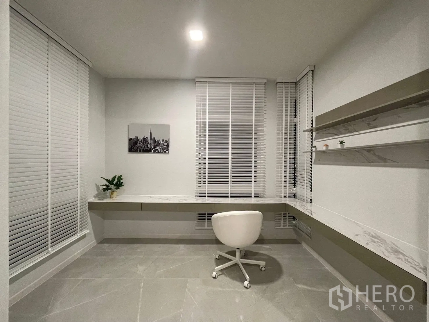 Detached House for rent in Prawet, Bangkok - Home office with long built-in desk, shelves, blinds, and swivel chair.