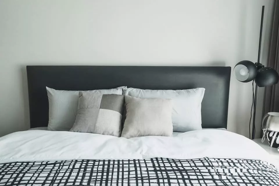 Detached House for rent in Bang Phli, Samut Prakan - Minimalist bedroom featuring a black headboard, neutral bedding and a floor lamp.