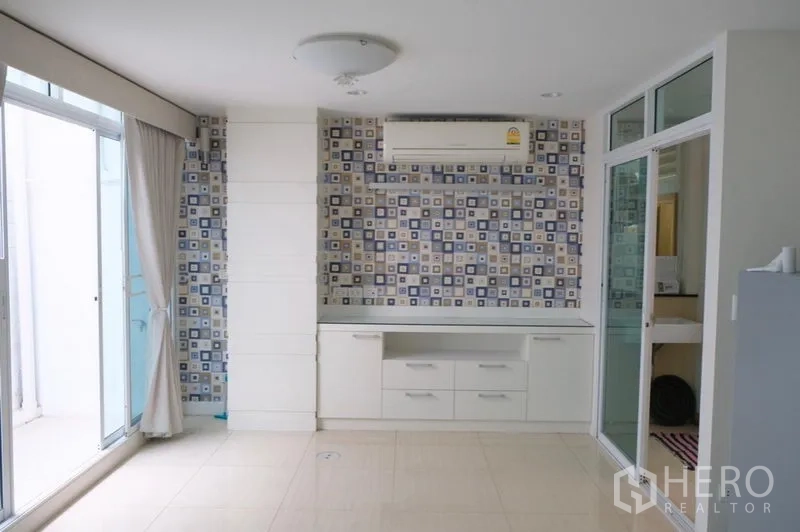 ทาวน์เฮาส์ ให้เช่าในKhlong Toei, Bangkok - ห้องสว่างผนังลายกระเบื้องและประตูกระจกบานเลื่อนออกสู่เทอเรซ