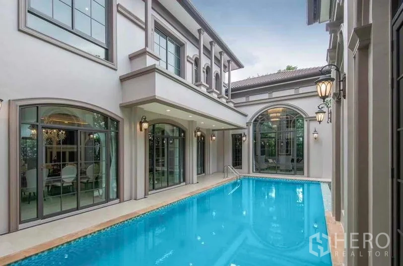 Detached House for rent or sale in Thawi Watthana, Bangkok - View of the lap pool beside the house with classic lanterns and arches.