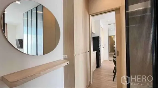 คอนโด ให้เช่าในWatthana, Bangkok - โถงทางเดินมี กระจกกลมและชั้นไม้ มุ่งสู่ครัวแพนทรี่และมุมทานอาหาร