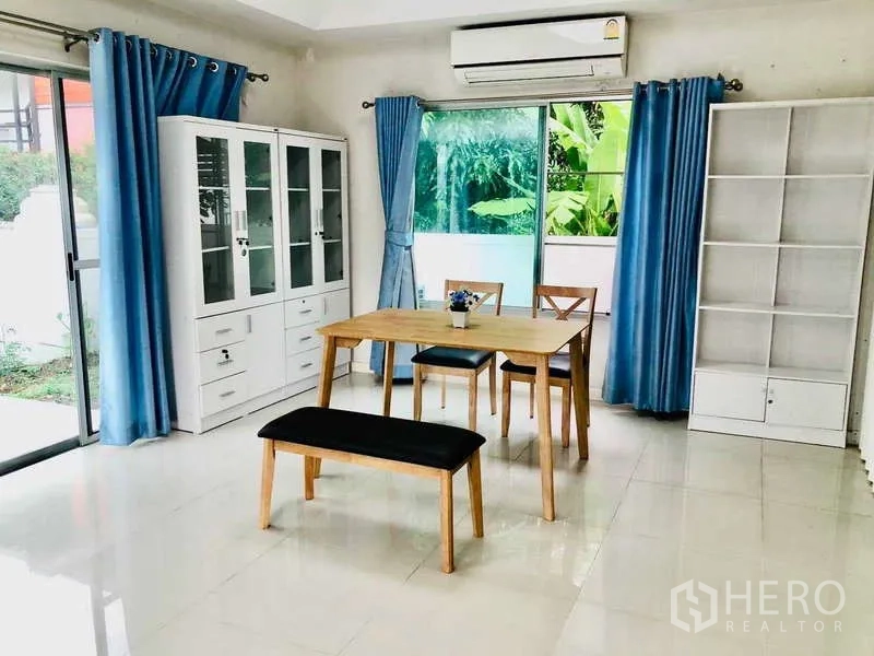 Detached House for rent or sale - Dining area with wooden table, bench and blue curtains.