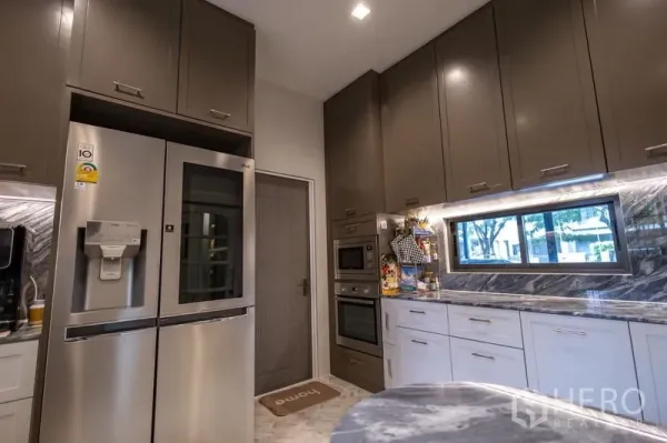 Detached House for sale in Pak Kret, Nonthaburi - Gourmet kitchen with marble backsplash, tall cabinets, double ovens and stainless steel refrigerator.