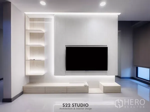 Detached House for rent in Bang Phli, Samut Prakan - Minimalist living room feature wall with large mounted TV, backlit shelves and cabinets.