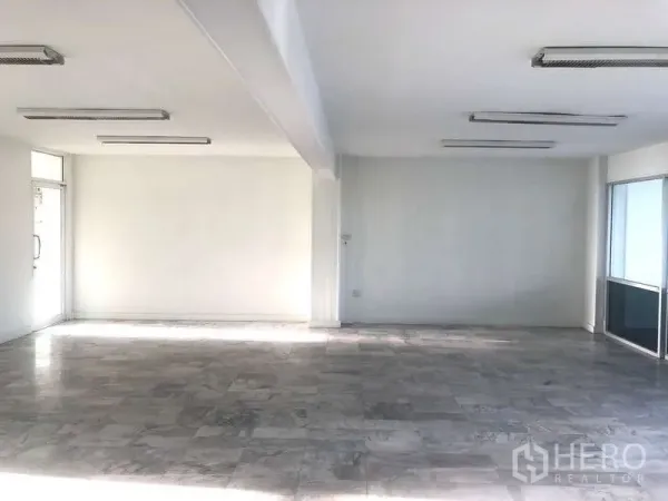Office Space for rent in Bang Kapi, Bangkok - Spacious unfurnished office area with fluorescent ceiling lights and tiled floors ready for layout customization.