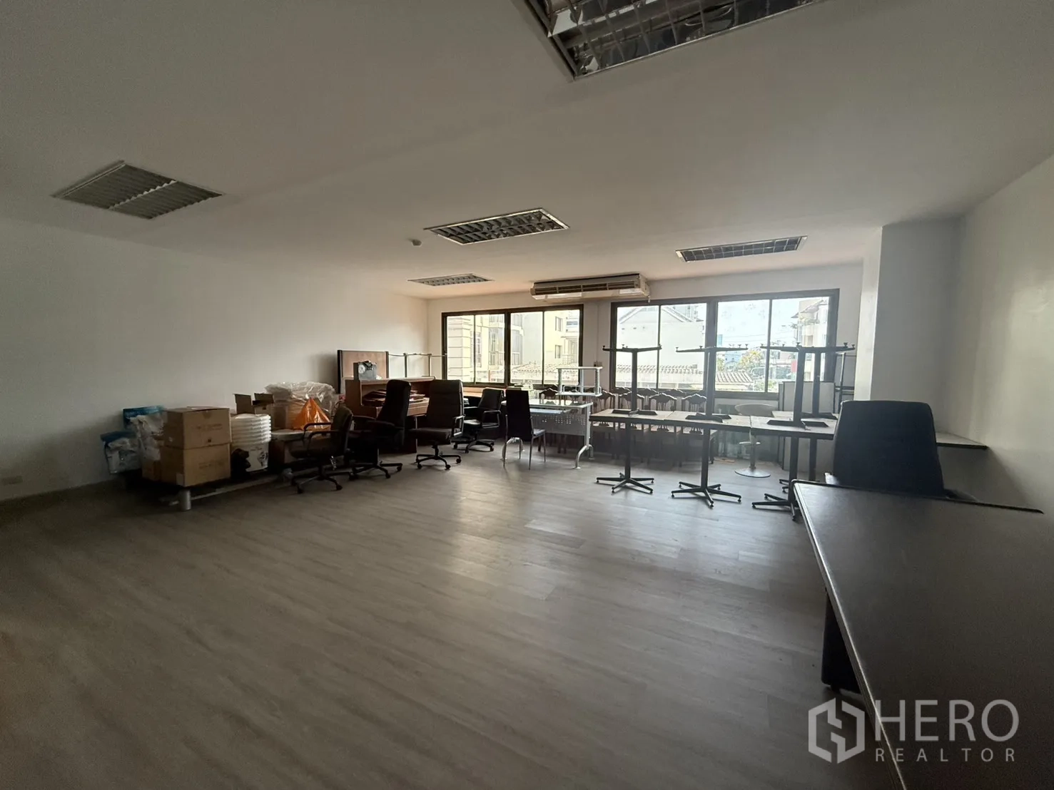 Office Space for rent in Sathon, Bangkok - Spacious 60 sqm office showing air-conditioning above the windows, open layout, and movable tables for flexible setups.