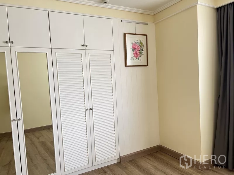 คอนโด ให้เช่าในKhlong Toei, Bangkok - ตู้เสื้อผ้าบิวท์อินบานเกล็ดสีขาวพร้อมกระจกเงาในห้องนอน