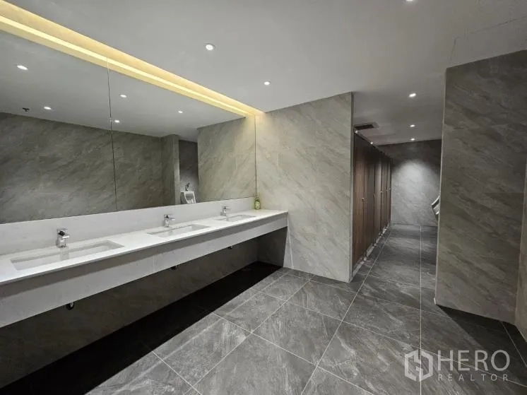 办公空间 出租在Bang Rak, Bangkok - 翻新洗手间，超长洗手台、下嵌式水槽与瓷砖地墙。