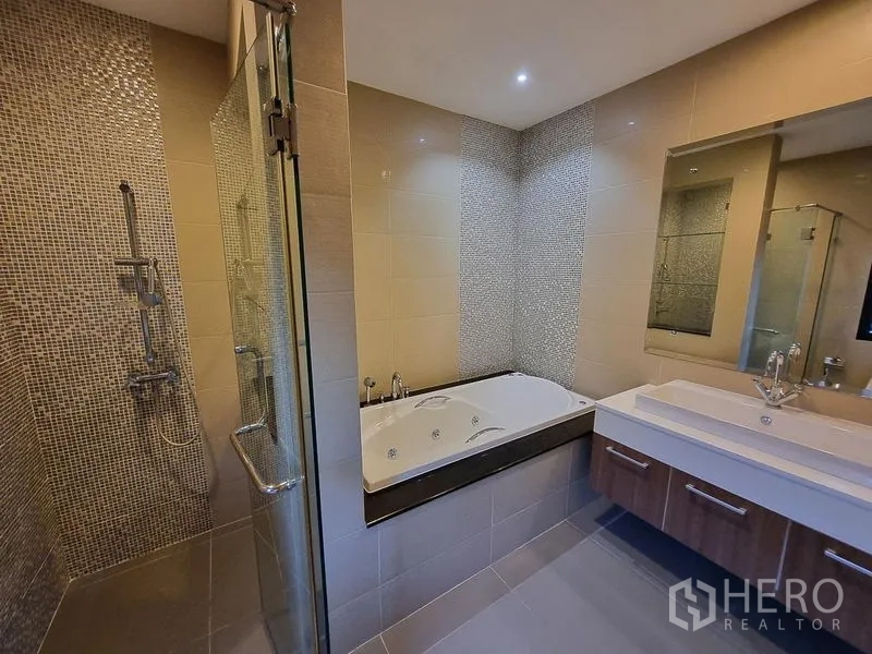 Detached House for rent in Bang Khae, Bangkok - Bathroom with glass shower, mosaic accent wall, bathtub, and double vanity.