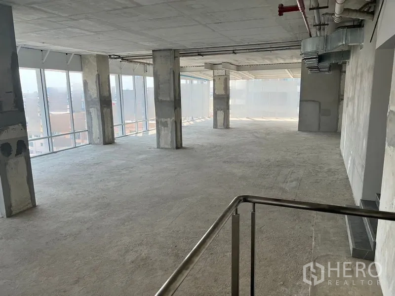 Office Space for rent in Sathon, Bangkok - Shell-and-core open-plan office floor with concrete columns, exposed ducts and floor-to-ceiling windows near Chong Nonsi.