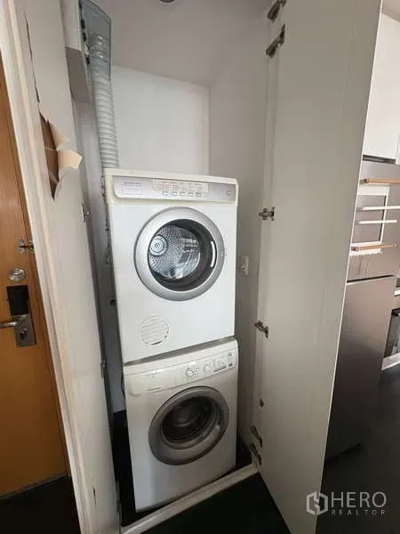 Condominium for rent - Stacked washer and dryer neatly concealed in a built-in closet.