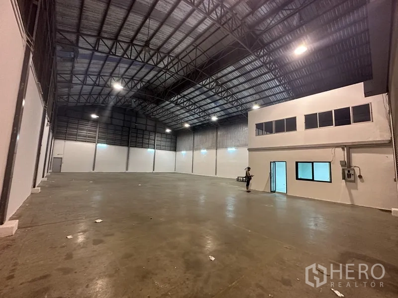 货栈 出租在Bang Phli, Samut Prakan - 高挑拱顶仓库内部，带夹层办公室与混凝土地坪。