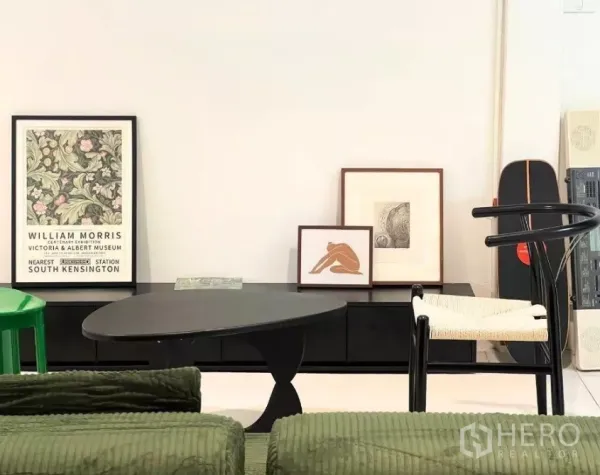 ทาวน์เฮาส์ ให้เช่า - มุมนั่งเล่นสไตล์มินิมอล โซฟาสีเขียว โต๊ะกลางสีดำ และกรอบรูปตกแต่ง