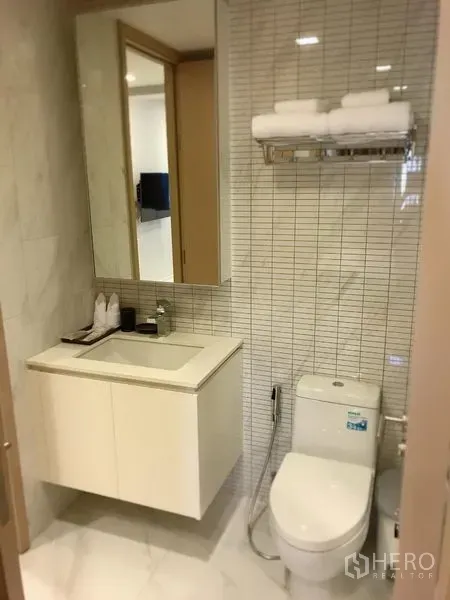 คอนโด ให้เช่าในWatthana, Bangkok - ห้องน้ำโมเดิร์น ผนังกระเบื้อง เคาน์เตอร์ซิงก์พร้อมตู้กระจก โถสุขภัณฑ์ และชั้นวางผ้าเช็ดตัว