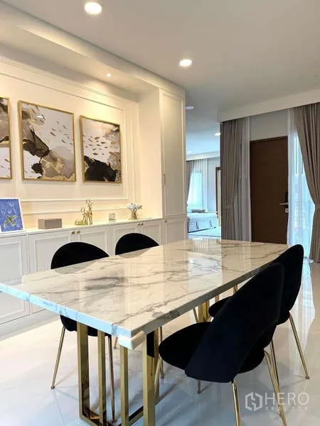 Detached House for rent in Bang Phli, Samut Prakan - Dining area with marble-top table, gold legs and wall art in a bright open space.