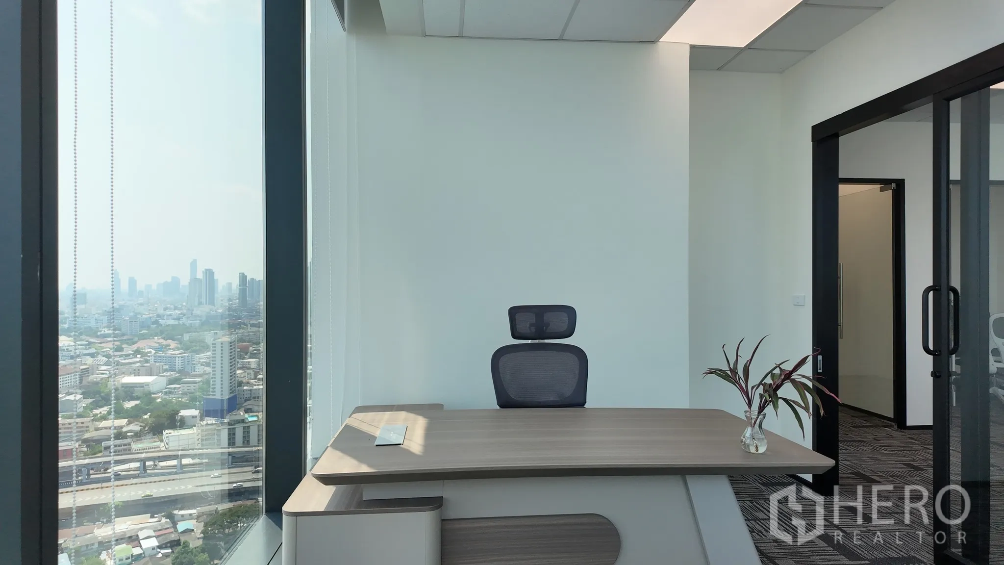 Office Space for rent in Khlong Toei, Bangkok - Private manager’s office with modern desk, glass door, and skyline backdrop.